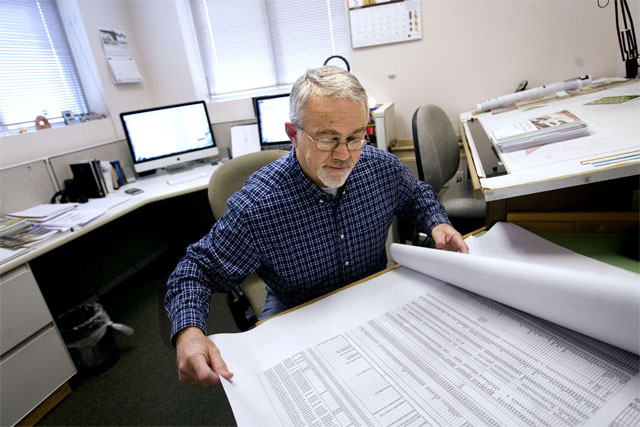Barry Welliver, consulting structural engineer, looks over paperwork at his Draper office on Friday, Jan. 21, 2011. (Laura Seitz, Deseret News)