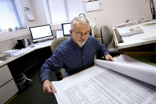 Barry Welliver, consulting structural engineer, looks over paperwork at his Draper office on Friday, Jan. 21, 2011. (Laura Seitz, Deseret News)