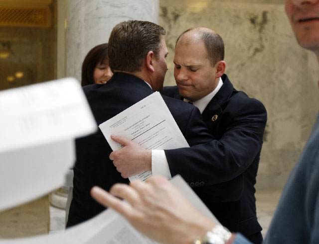 At right, Utah Senator Daniel W. Thatcher hugs Craig Frank after Frank announces his resignation as the Utah State Representative from District 57 during a news conference at the Utah Capitol building in Salt Lake City, Utah Friday, Jan. 21, 2011. At back left is Frank's wive Kim Frank. (Ravell Call, Deseret News)