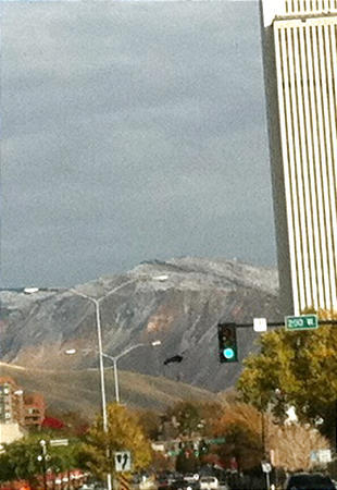 A base jumper, just left of the green traffic light in black, jumped from the LDS Church Office Building seen at right. (Randal Longstroth, for the Deseret News)