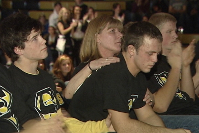 Dale Lawrence's mother, Kelly Giles, comforts Dale's teammates during Wasatch High School's Senior Night program Jan. 13