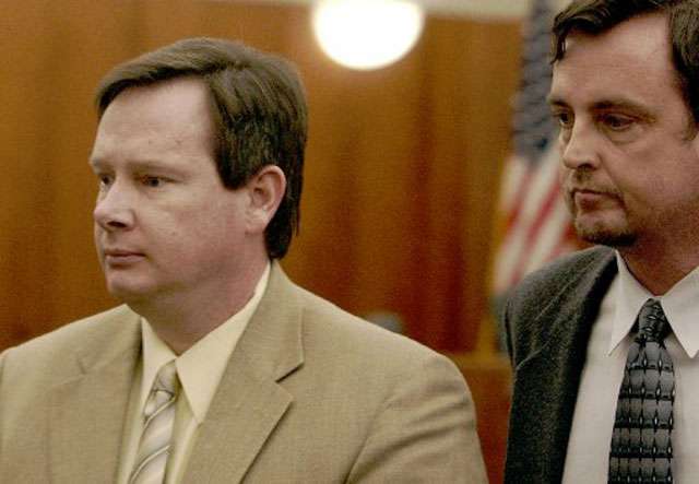 Mark Ott, left, is lead away by attorney Aric Cramer after being sentenced to life in prison without parole, in Second District Court, in Farmington, Utah, Friday, April 2, 2004. (AP Photo/Brian Nicholson, Pool)