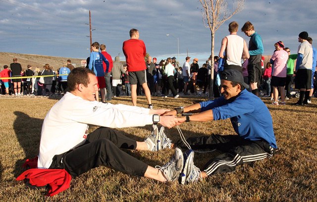 Running guide Clinton Rhoton, 22, left, and Adrian Broca, left, who is blind, stretch before the start of the St. George Half Marathon Saturday Jan. 22, 2011. (Taylor Wilson, KSL 5 News)