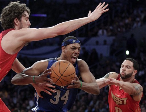 East's Paul Pierce drives between West's Deron Williams, right, and Pau Gasol during the NBA basketball All-Star Game in Los Angeles. (AP Photo/Jae C. Hong)