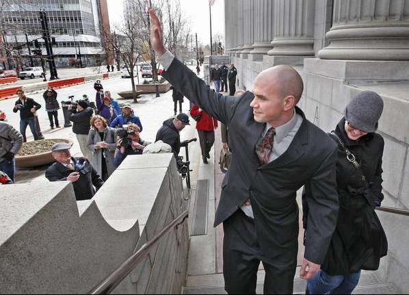 Tim DeChristopher waves to supporters across the street demonstrating as he enter Federal Court for trial for facetiously staking a claim to 13 parcels of land for nearly $1.8 million, which could send him to jail for 10 years, Monday, Feb. 28, 2011, in Salt Lake City, Utah. (Tom Smart, Deseret News)