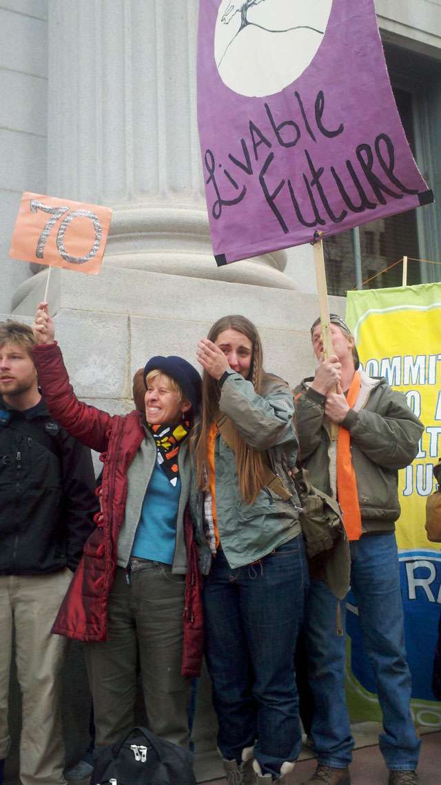 Upon hearing the verdict, supporters and protesters outside of the downtown federal courthouse stood arm in arm, their hands clasped as they sang and swayed. (Sarah Dallof, KSL 5 News)