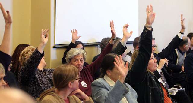 People raise their hands to show they wish to comment on HB477, which addresses GRAMA rules, during a Senate committee meeting at the Utah Capitol in Salt Lake City, Utah Friday, March 4, 2011. The bill passed in committee. (Ravell Call, Deseret News)