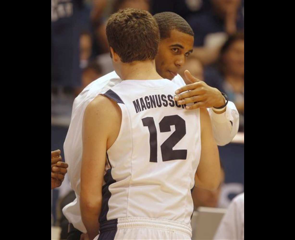 BYU's Brandon Davies, right, is hugged by his teammate Logan Magnusson during a game against Wyoming. (AP Photo/George Frey)