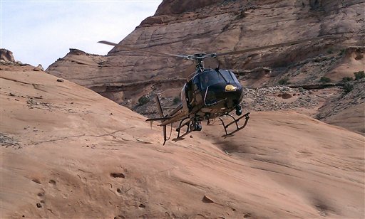In this March 12, 2011 image provided by the Wayne County, Utah, Sheriff's Department, a Search and Rescue Team helicopter descends to rescue 57-year-old David Cicotello at No Man's Canyon in southeastern Utah. (AP Photo/Wayne County Sheriff's Department)