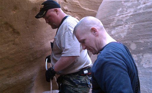 This March 12, 2011 image provided by the Wayne County, Utah, Sheriff's Dept. shows unidentified members of the sheriff's search and rescue team near the site of an extraction in No Man's Canyon in southeastern Utah. (AP Photo/Wayne County Sheriff's Department)