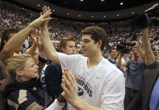 BYU's Jimmer Fredette celebrates with the crowd after a win against Wyoming at an NCAA college basketball game in Provo, Utah, Saturday, March 5, 2011. BYU beat Wyoming 102-78 to win the Mountain West Conference Championship. (AP Photo/George Frey)