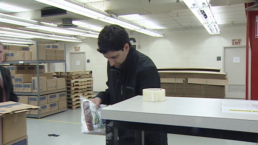 Daniel Seddiqui author of "50 Jobs in 50 States" revisits his job as a volunteer packing hygiene kits at the LDS Humanitarian Center in on Tuesday.