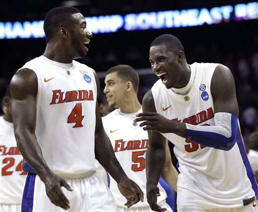 Florida's Vernon Macklin (32) and Patric Young (4) react after overtime of the NCAA Southeast regional college basketball semifinal game against BYU. (AP Photo/David J. Phillip)