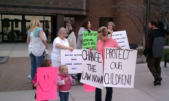 Family members of Lonnie Johnson's alleged victims protested outside the courthouse during Thursday's hearing.