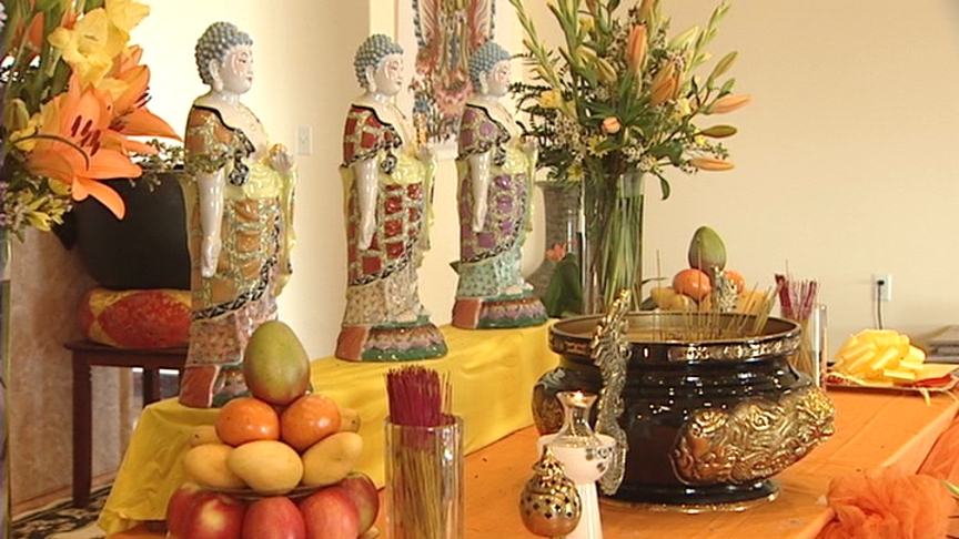 Members of the faith left offerings of fruit and flowers to Buddha.