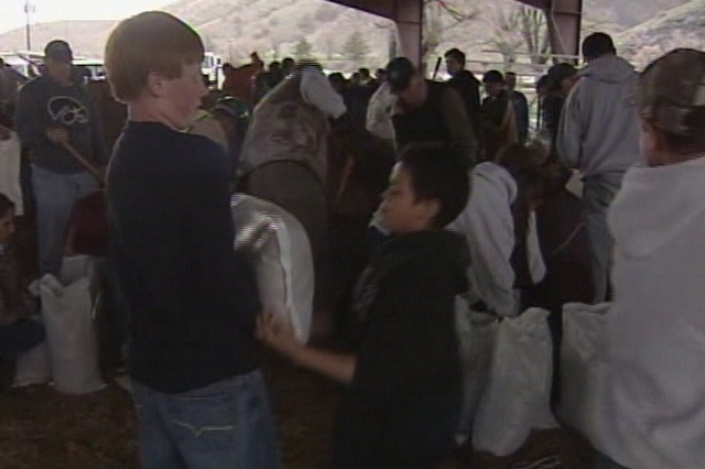Morgan County residents gathered at the county fairgrounds Monday evening to fill sandbags and deliver them to flood-stricken areas.