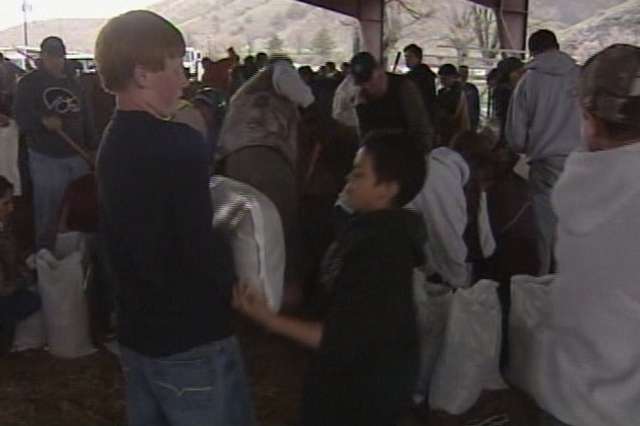 Morgan County residents gathered at the county fairgrounds Monday evening to fill sandbags and deliver them to flood-stricken areas.