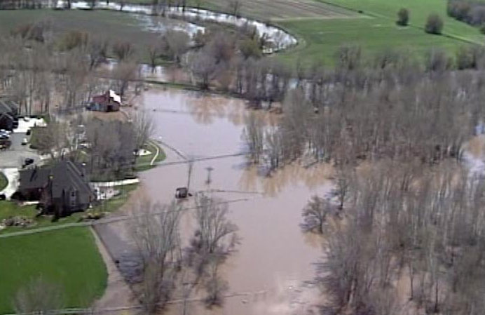 Several farm fields and homes in Plain City were flooded from what has turned the main breach of the Weber River into a 100-foot wide gap.