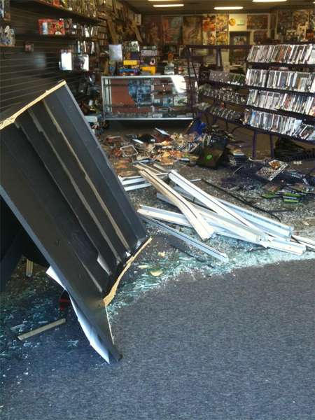 Car smashes through comic shop