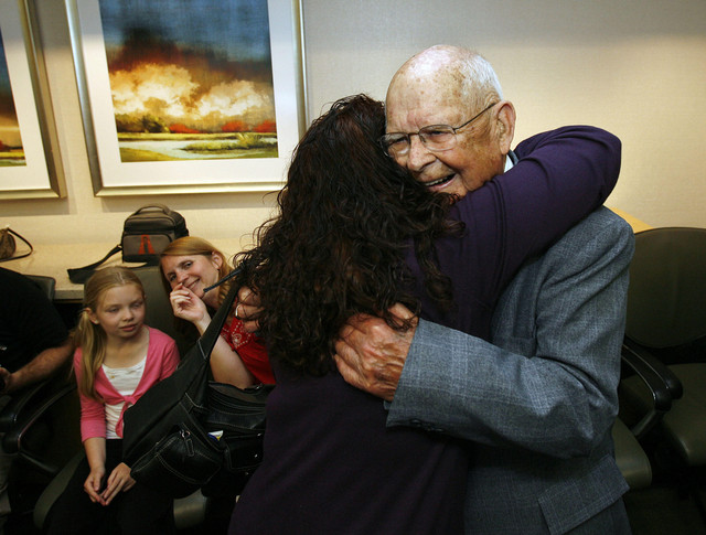 Herbert Russell, right, 87, is hugged by his granddaughter, Debra Cox, as he is honored for 56 years of volunteer hospital service.