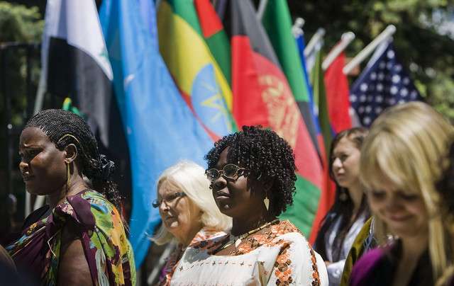 Alual Majok and Ajak Akut, who are originally of South Sudan, listen to Salt Lake County Mayor Peter Corroon speak at the kickoff of Refugee Awarness Month organized by the Utah Refugee Coalition at the International Peace Gardens in Salt Lake City