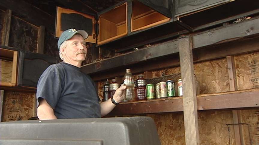 Groundskeeper Leslie Dejong shows what's left of the merchandise inside the charred snack shop at Bruce Field.