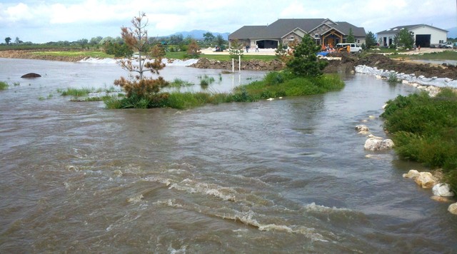 Officials work at the site of the levee break in West Warren Thursday, June 9, 2011.