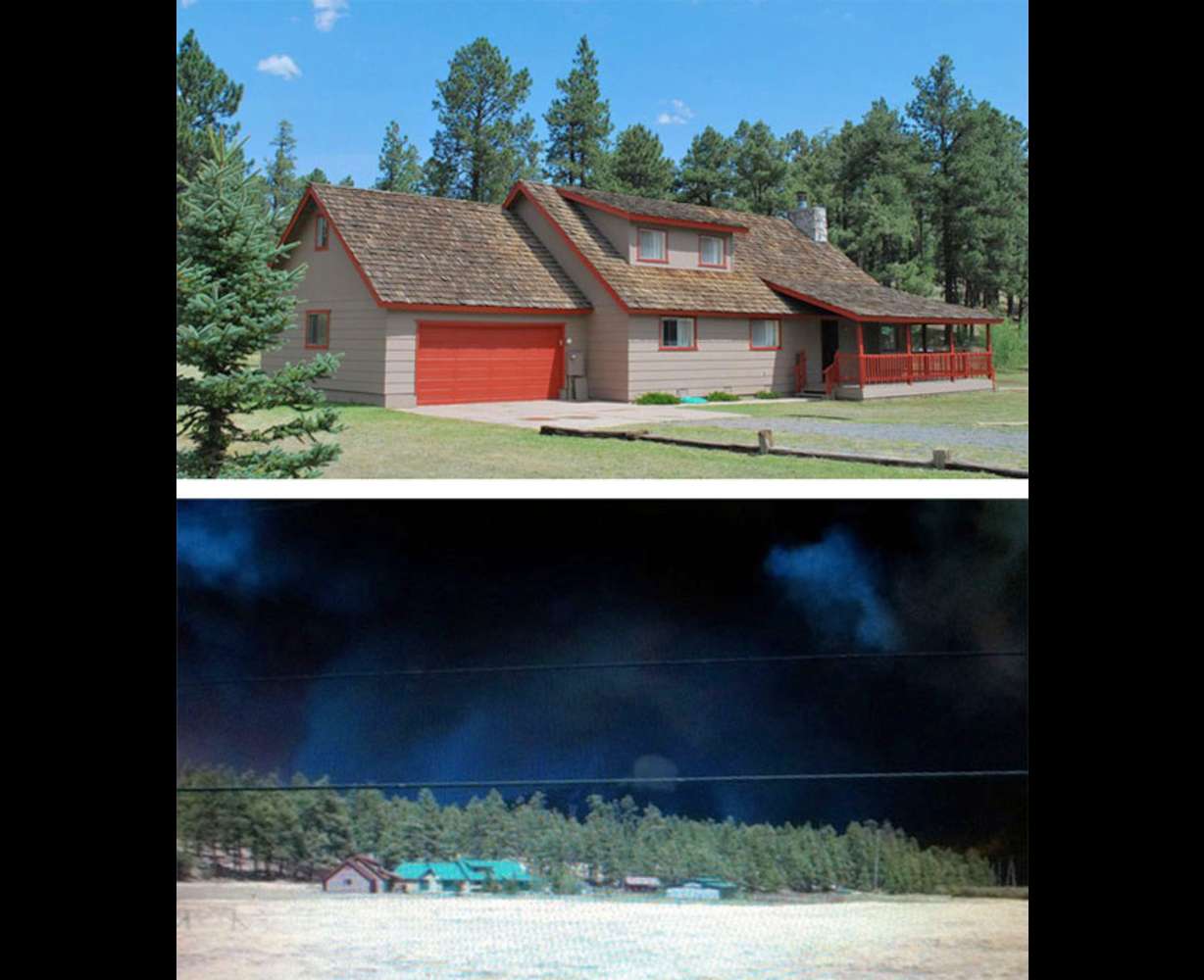 The cabin, above, before the fire. Below, nearly enveloped with smoke, the cabin sits in the bottom left of the photograph.