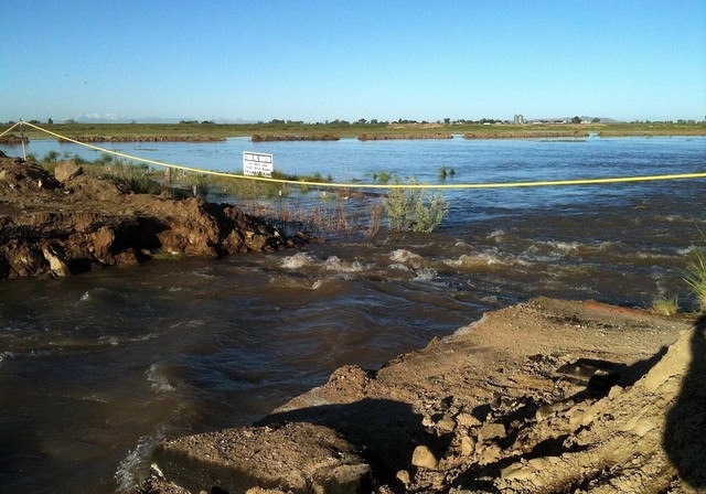 Water flows rapidly in the area of Warren, Weber County, Friday, June 10, 2011, where a levee broke.