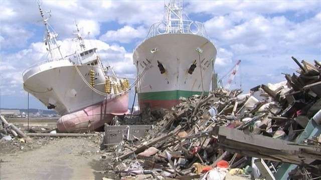 Toppled ships lying in the middle of a once-upscale Japanese neighborhood have become an intrusion, clearly out of place.