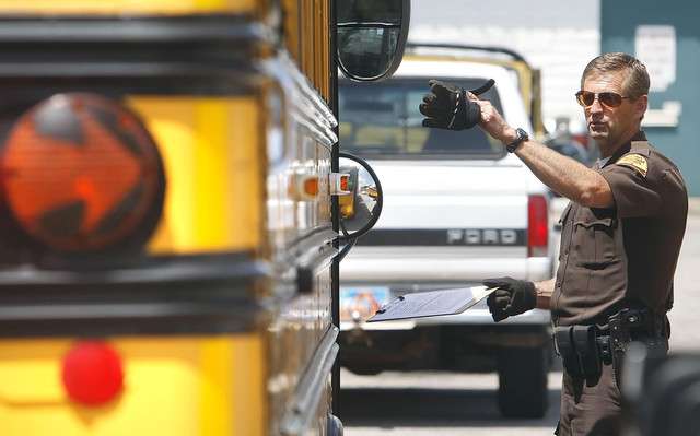 Utah Highway Patrol troopers conduct an inspection of the bus as they investigate an accident Monday, June 20, 2011, where a 17-year-old special needs student either fell or jumped out of the back of a Granite School District school bus.