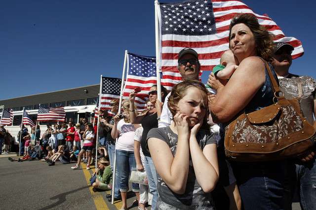Family members of Sgt. Jeff Stevens watch as he leaves in a helicopter. At front center is Naudia Cote, a niece.