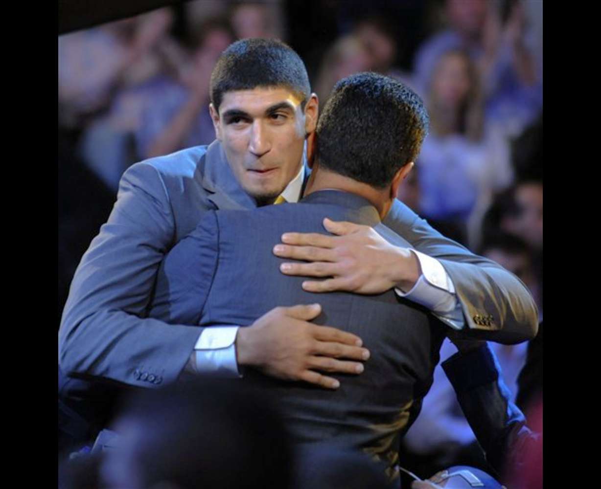 Enes Kanter, from Turkey, who was selected with the No. 3 pick by the Utah Jazz, gets a hug at the NBA basketball draft Thursday, June, 23, 2011, in Newark, N.J. (AP Photo/Bill Kostroun)