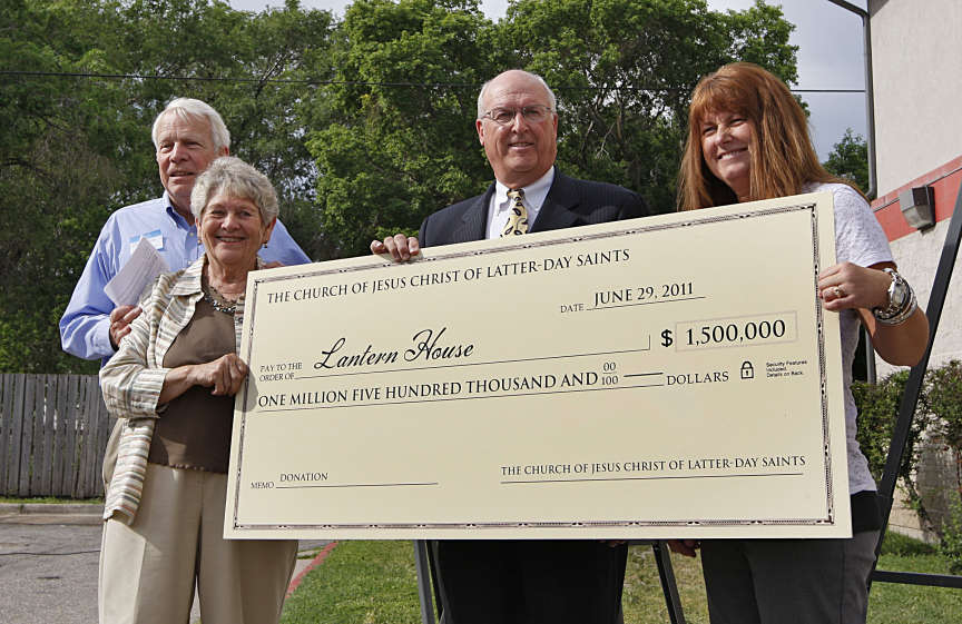 Campaign chairs Allan and Kay Lipman, left, and St. Anne's Executive Director Jennifer Cantor receive a $1.5 million ceremonial check from Ron Humphries, Director of Temporal Affairs for the LDS Church.(Tom Smart, Deseret News)