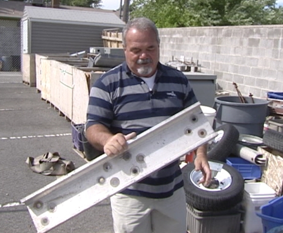 Pastor Dan Grinder shows an example of they type of aluminum the thieves are taking.