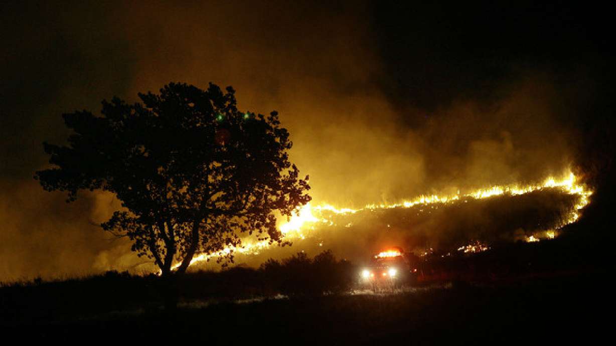 Firefighters work to contain a fire on the foothills above North Ogden on Aug. 6, 2011. The Ogden fire marshal has issued restrictions on fireworks and open flames in the city through mid-October because of forecasted hot and dry weather.