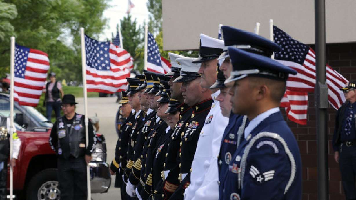 A color guard waits to carry the remains of 16 at the Utah Veterans Cemetery and Memorial Park, Aug. 15, 2001. Utah veteran organizations are urging the state’s vets to file for PACT Act benefits by Wednesday in anticipation of the act’s first anniversary.