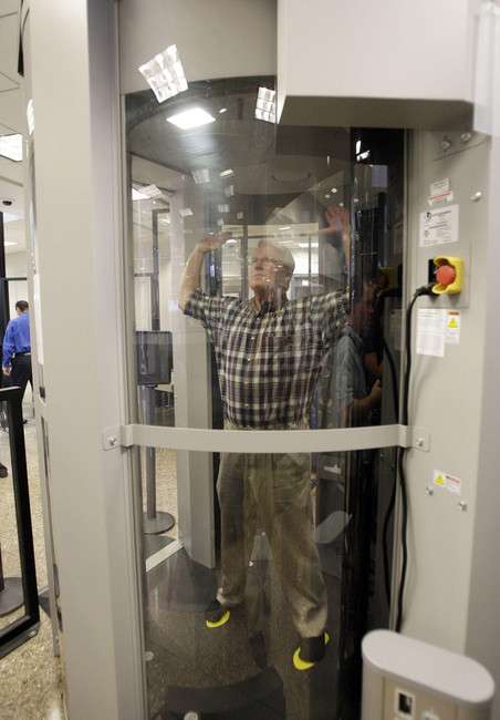 TSA demonstrator John Inderrieden shows how air travelers with be scanned using new Automatic Target Recognition software at the Salt Lake International Airport.