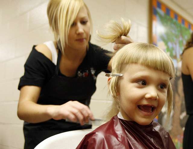 Luella Sturgeon, right, gets a haircut from Carly Curnutt at the Road Home Shelter.