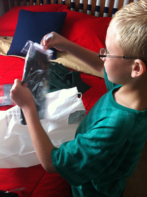 Jensen Coombs gets his clothes ready prior to attending a charter school.