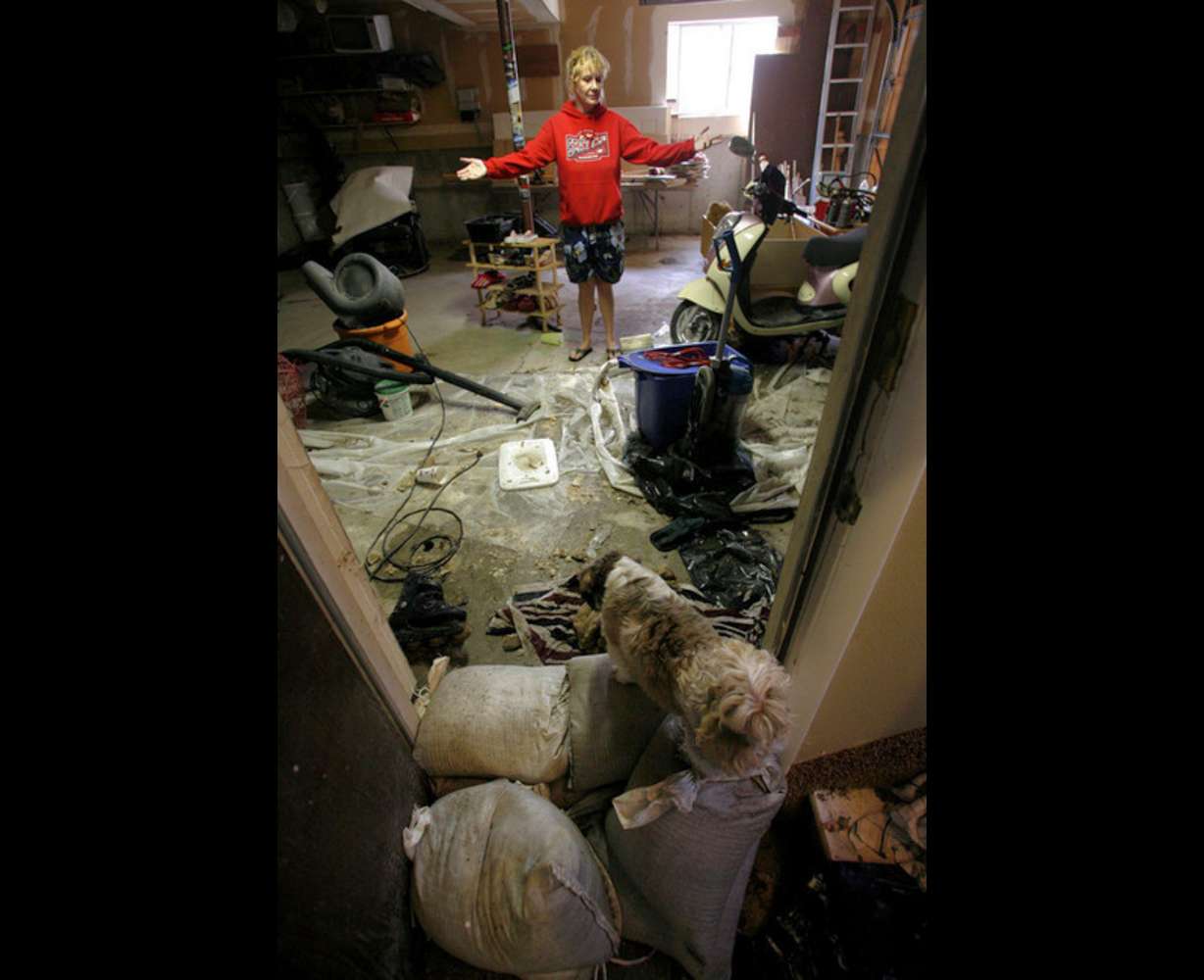 Gloria Miller shows flood damage from a storm drain that overflowed in front of her house in Murray on Monday, Aug. 29, 2011. (Photo: Kristin Murphy, Deseret News)