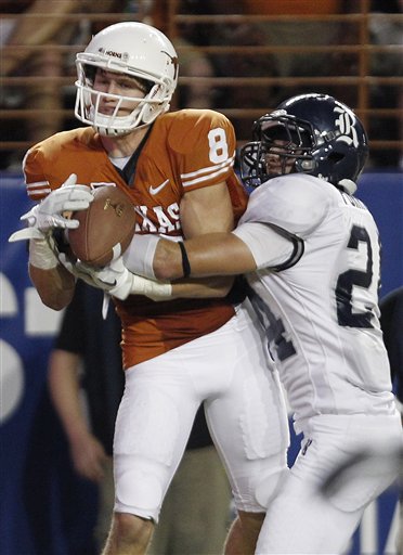 Texas' Jaxon Shipley (8) pulls in a touchdown pass as Rice's Paul Porras, right, defends. (AP Photo/Eric Gay)