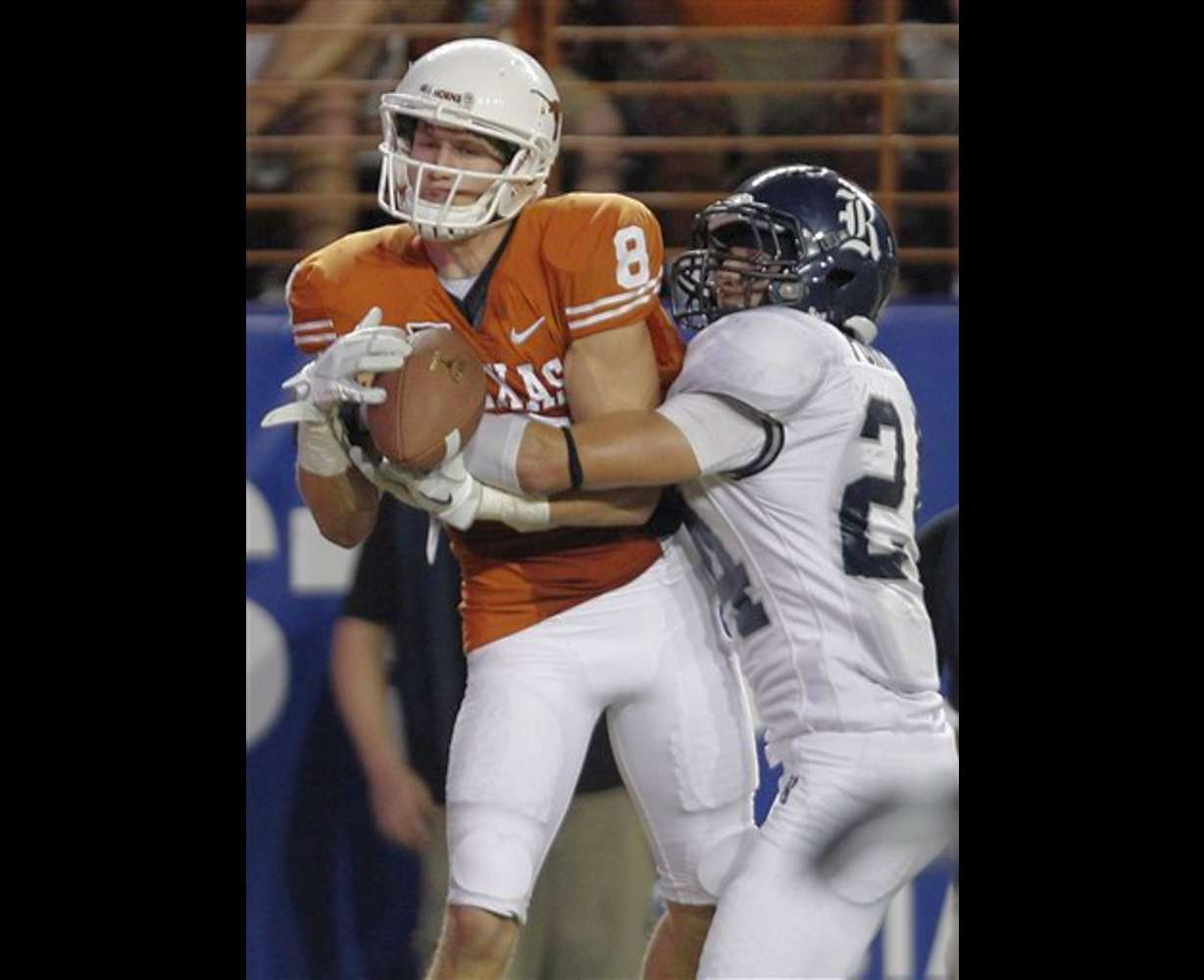 Texas' Jaxon Shipley (8) pulls in a touchdown pass as Rice's Paul Porras, right, defends. (AP Photo/Eric Gay)