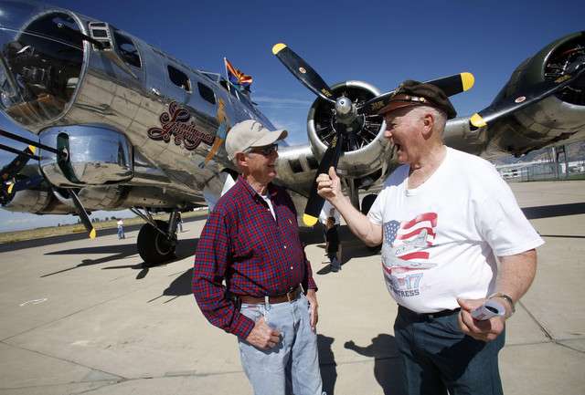 J.R. Eccles, former F-86 pilot, talks with Ray
Hobbs, who flew orientation missions and mercy
missions in a B-17, in front of a B-17G at the
Ogden Hinckley Airport in Ogden on Monday, Sept.
19, 2011.