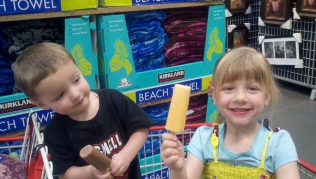 Two-year-old Collin, left, and 4-year-old Savannah, right, enjoy
popsicles at Costco with their Papa Dave.