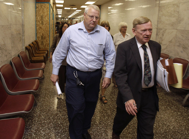 Chuck Cox, left, the father of missing Utah woman Susan Powell, walks with attorney Steve Downing, right, as they leave a Pierce County courtroom, Friday, Sept. 23, 2011, in Tacoma, Wash. Cox was attending a hearing regarding a motion he filed seeking custody of his two grandchildren. (AP Photo/Ted S. Warren)