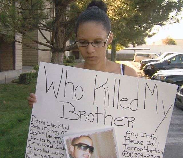 Quartena Hooper, Demi's sister, shows the sign
she plans to display when she and other family
members return to the scene of the crash
Saturday to and post fliers in hopes of finding
out more information about her brother's death.
