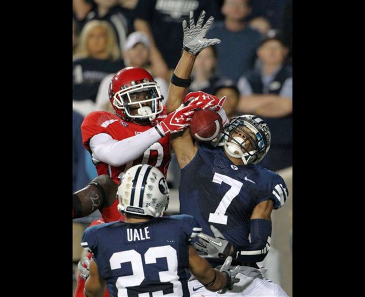 Utah wide receiver DeVonte Christopher (10) is unable to come up with a 14-yard pass by Jordan Wynn in the end zone, as BYU cornerback Preston Hadley (7) and safety Travis Uale (23) defend. (AP Photo/Colin E Braley)