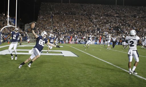 BYU TE Marcus Mathews celebrates after catching 
the game-winning touchdown against Utah State 
(Deseret News)
