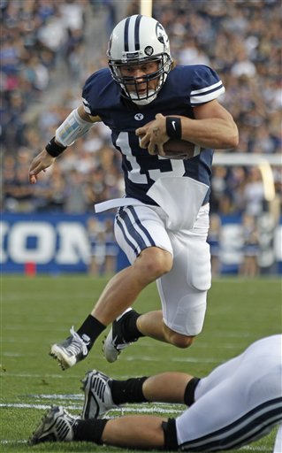 BYU quarterback Riley Nelson runs the ball against Utah State. (AP Photo/George Frey)